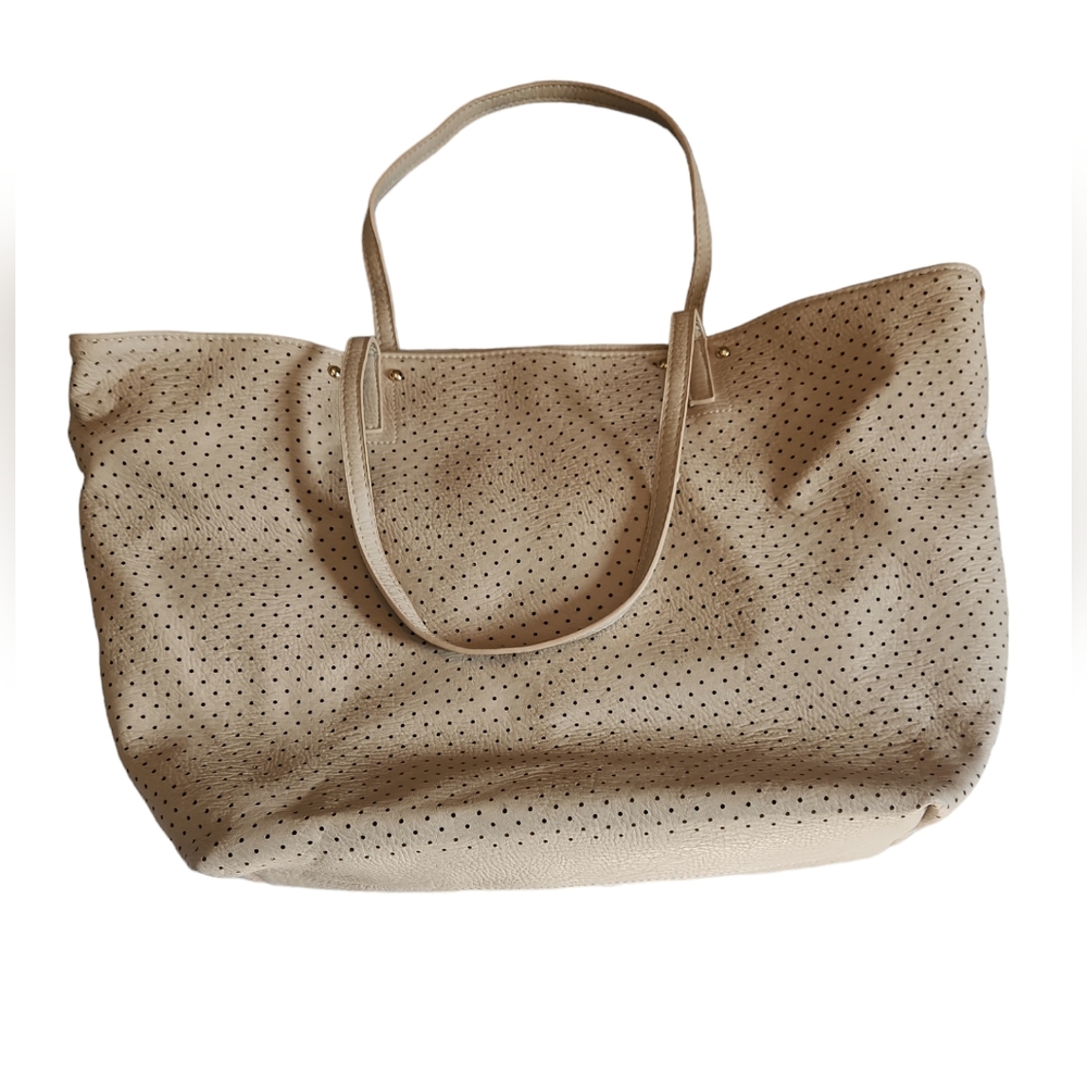 Under One Sky tan purse. Four zippers two inside and two outside. Dots design
